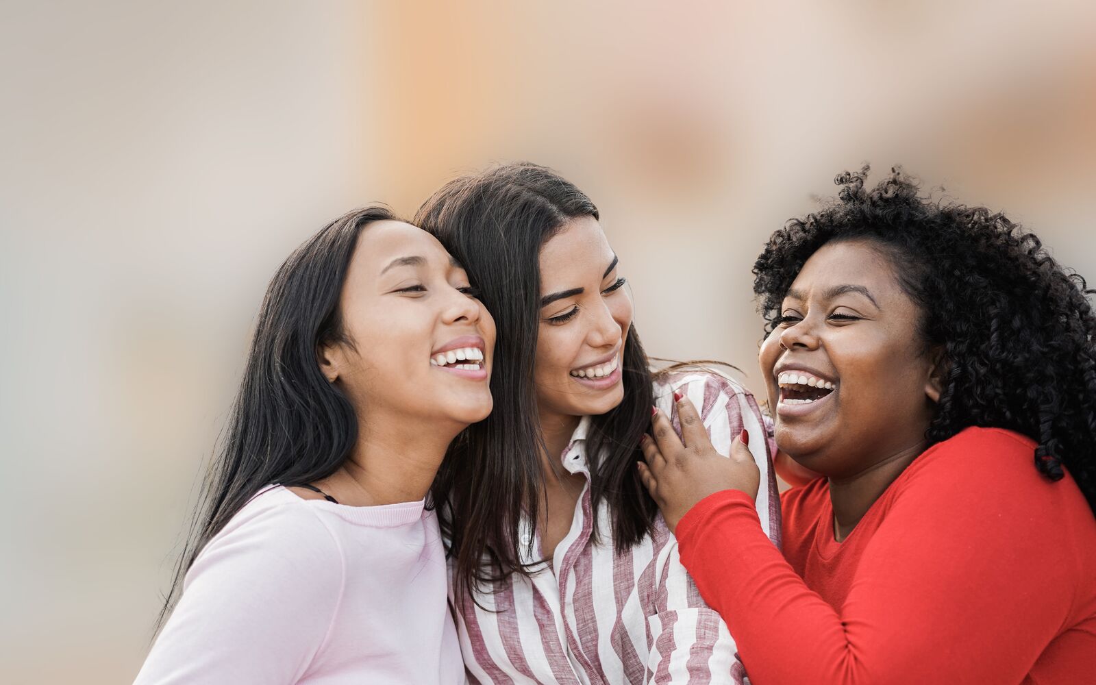 Happy latin girls enjoy time together outdoor around city - Friendship and diverse ethnicity concept - Main focus on black woman face; Shutterstock ID 1931246621; purchase_order: Main Visual; job: ; client: ; other: